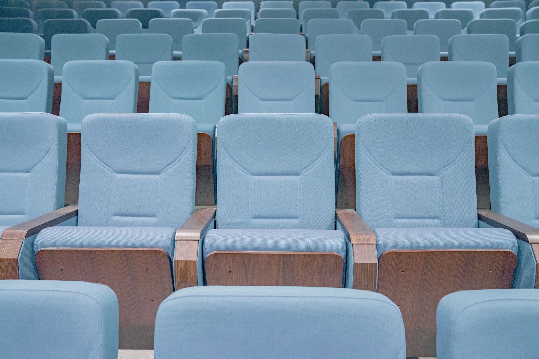 Rows of pale blue auditorium seats